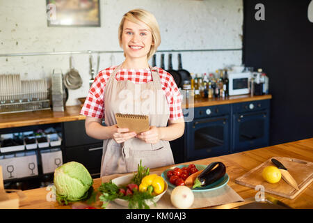 Attractive Housewife with Notepad Stock Photo