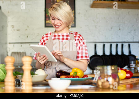 Using Digital Tablet in Kitchen Stock Photo