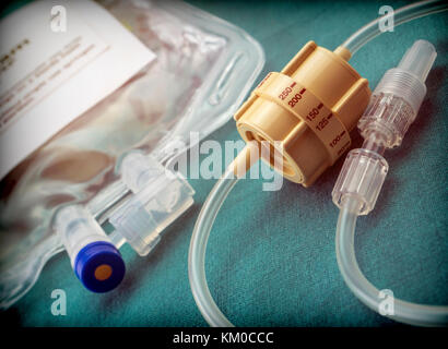 Dial flow regulator next to medicine bag in a hospital, conceptual image Stock Photo