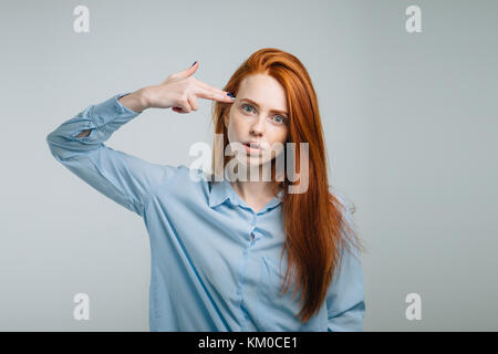 Bang, Bang. Serious Self Confident Ginger Young Female Shows Finger Gun  Gesture, Points Directly At Camera, Dressed In Red Casual Sweater, Poses  Against White Background, Approves Somebodys Idea. Stock Photo, Picture and