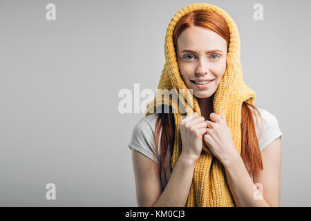 redhead girl wearing knit sweater on head as headscarf Stock Photo