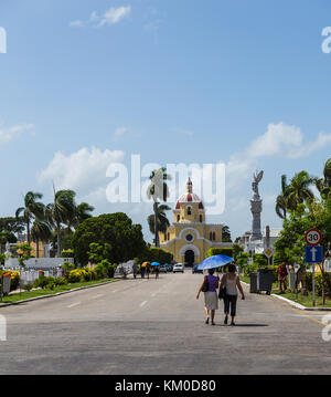 Two middle aged women walk towards the main chapel in Colon Cemetery to attend a funeral during August 2014. Stock Photo