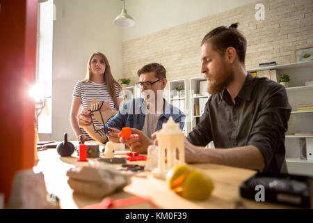 Group of Design Students Using 3D Printer Stock Photo