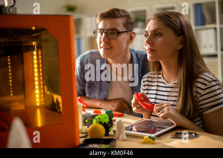 Couple of Students Using 3D Printer Stock Photo