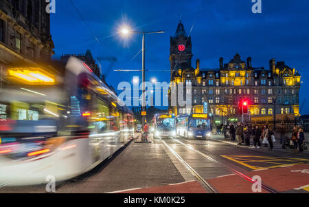 Night view of Princes Street with tram and buses and Balmoral Hotel to rear in Edinburgh, Scotland, United Kingdom. Stock Photo