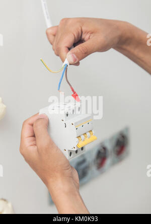 An electrician working on a power socket/plug during house renovations. Stock Photo