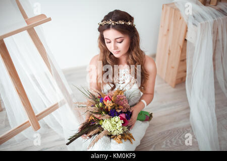 Beautiful bride with wedding bouquet on white background Stock Photo