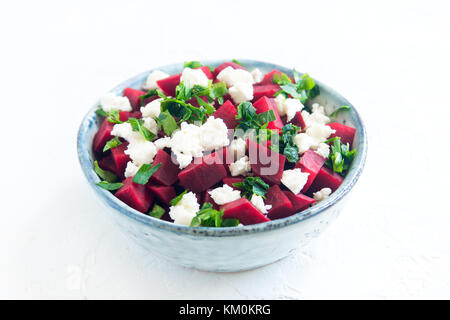 Beet and Feta Cheese Salad with Parsley isolated on white. Healthy vegetarian diet detox vegan raw food. Vegetable and protein food - beet and feta sa Stock Photo