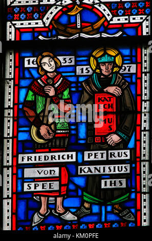 Stained Glass in Wormser Dom in Worms, Germany, depicting Friedrich Spee and Petrus Kanisiuis or Peter Canisius, famous Jesuit priests during the Cont Stock Photo