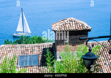 View of Lake Garda over red tiled rooftops. Stock Photo