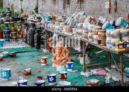 Ceramic earthenware statue of elephant god Ganesh and pots on display for sale as tourist souvenirs, Amritsar, north-western India, Punjab Stock Photo