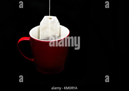 Red cup, mug of tea on black with copy space. Blank, red mug. herbal infusion etc also. Stock Photo
