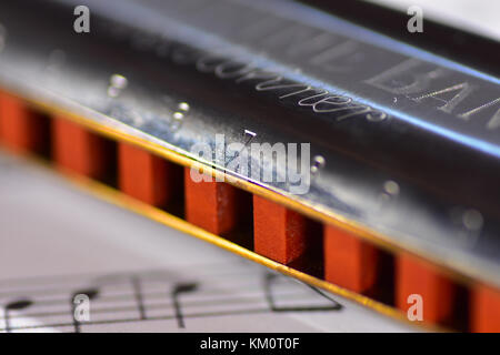 Harmonica on a sheet of music Stock Photo