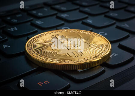 macro shiny bitcoin on computer keyboard. virtual cryptocurrency concept. Electronic money mining concept Stock Photo