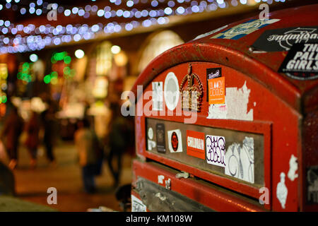 Mail box close up in Camden, London (UK) with blurred Christmas lights on the background. Landscape format. Stock Photo