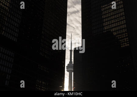 TORONTO, CANADA - DECEMBER 20, 2016: Canadian National Tower (CN Tower) surrounded by more modern buildings in downtown Toronto. CN Tower is the talle Stock Photo