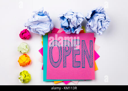 Writing text showing Open written on sticky note in office with screw paper balls. Business concept for shop Opening on white isolated background. Stock Photo