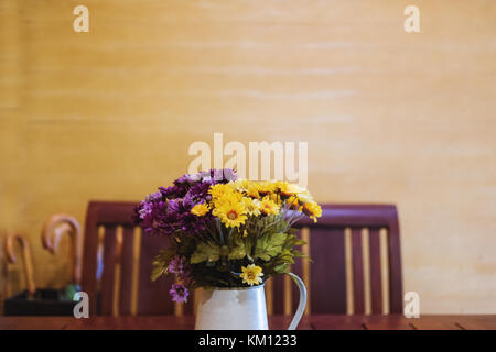 Flowers bouquet in vase, table decoration. Vintage tone, selective focus Stock Photo