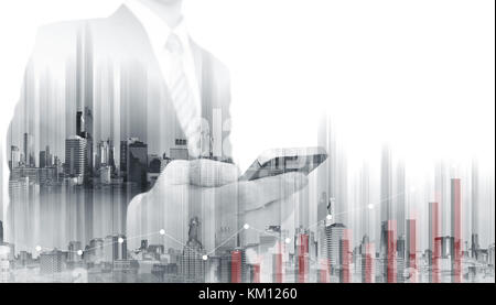 Double exposure Businessman using mobile smart phone with modern buildings. Business growth and investment Stock Photo