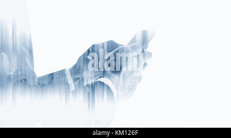 Double exposure businessman using mobile smart phone with modern buildings, on white background Stock Photo