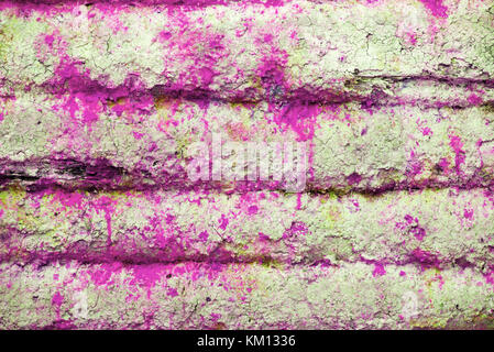 Background and wallpaper or texture of a pink wooden board with blue paint stains. Stock Photo