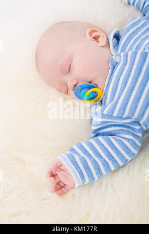Sleeping Baby lying down on fluffy fur Stock Photo