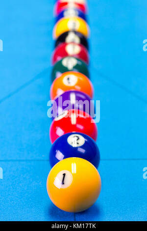 Billiard pool game balls lined up on billiard table with blue cloth, selective focus Stock Photo