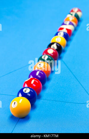 Billiard pool game balls lined up on billiard table with blue cloth, selective focus Stock Photo