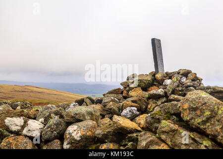 An old Boundary Stone on carnedd Y Filiast rests on a Cairn, Snowdonia National Park Stock Photo