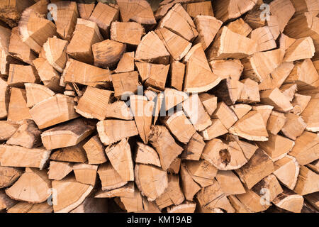 Background of dry chopped firewood logs in a pile Stock Photo