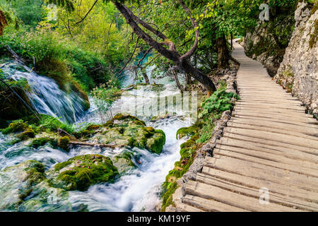 Boardwalk trail alongside cascading creek in Plitvice Lakes National Park, Croatia Stock Photo