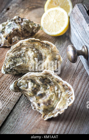 Raw oysters on the wooden background Stock Photo