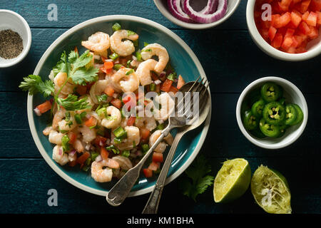 Delicious shrimp ceviche with tomato, red onion, jalapeno pepper, cilantro and lime. Stock Photo