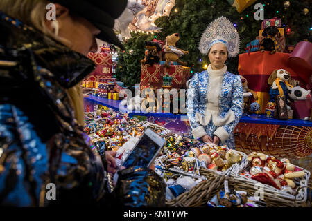 Saleswoman behind the counter at the New Year Fair in central Moscow store 'GUM', Russia Stock Photo