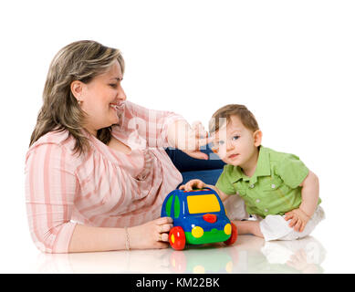 Mother playing with child holding car isolated on white Stock Photo