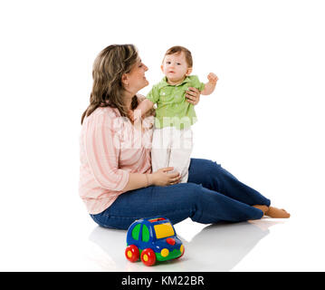 Mother playing with child holding car isolated on white Stock Photo