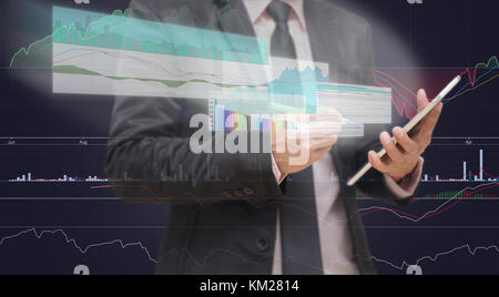 Businessman using the taplet shown the trading graph of stock market on the virtual screen over the stock chart background, Business stock market conc Stock Photo