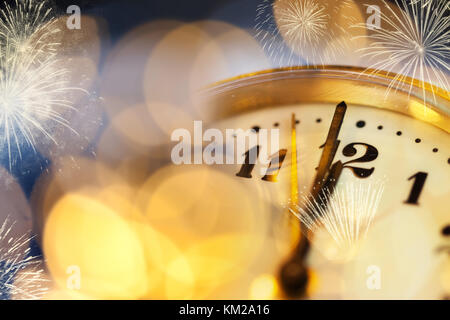 old clock at twelve o'cklock on holiday fireworks background - New Year's Stock Photo