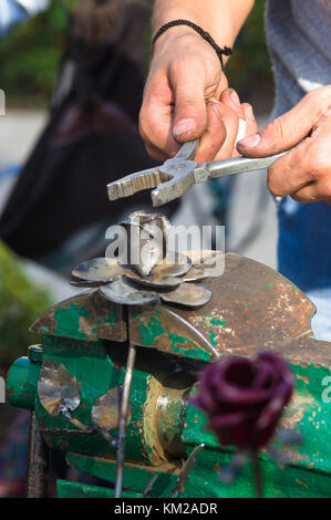 blacksmith and apprentice are made of iron rose handmade Stock Photo