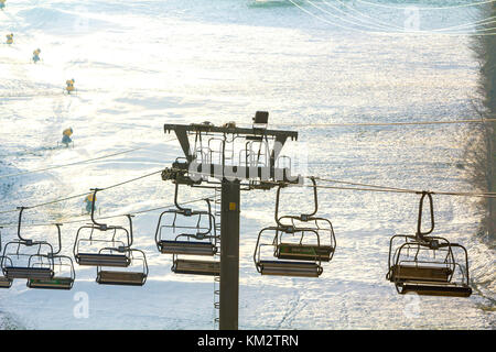 Ski lift with empty seats over the snow mountain in ski resort Stock Photo