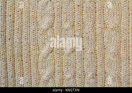 Background texture of beige pattern knitted fabric made of cotton or wool closeup Stock Photo