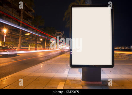 Blank advertisement mock up, with blurred traffic lights at night Stock Photo