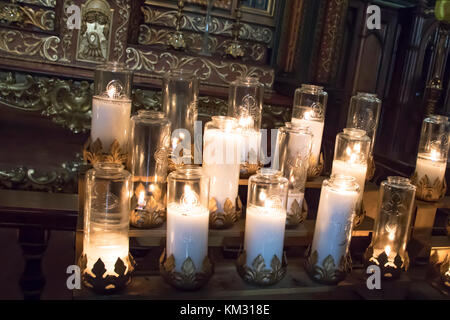 Prayer candles burnign in glass holders inside Basilica of Notre Dame, Montreal, Quebec, Canada. Stock Photo
