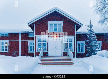 Snow covered Cottage in winter Rovaniemi, Lapland, Finland, at snowfall. Stock Photo