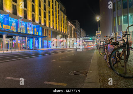 BERLIN, GERMANY - AUGUST 26, 2017;  Long exposure night image Friedrichestrasse retail shops line both sides of street with light streams from passing Stock Photo