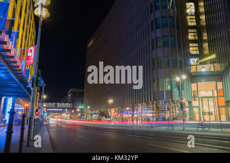 BERLIN, GERMANY - AUGUST 26, 2017;  Long exposure night image Friedrichestrasse retail shops line both sides of street with light streams from passing Stock Photo