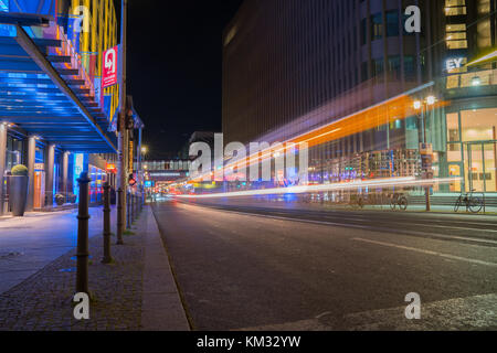 BERLIN, GERMANY - AUGUST 26, 2017;  Long exposure night image Friedrichestrasse retail shops line both sides of street with light streams from passing Stock Photo