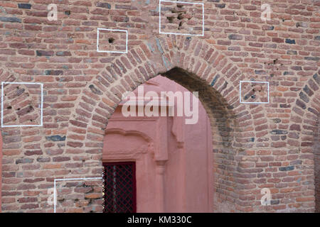 Machine gun bullet holes in brick wall at Jallianwala Bagh, Amritsar, where the British Army opened fire and massacred a crowd of unarmed protestors Stock Photo