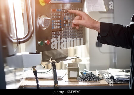 Cnc machine controls, male hand. Stock Photo