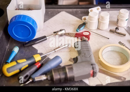Large amount of tools are lying on a metal plate. Stock Photo